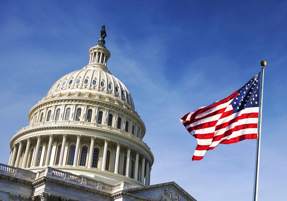 American flag waving with the Capitol Hill stock photo